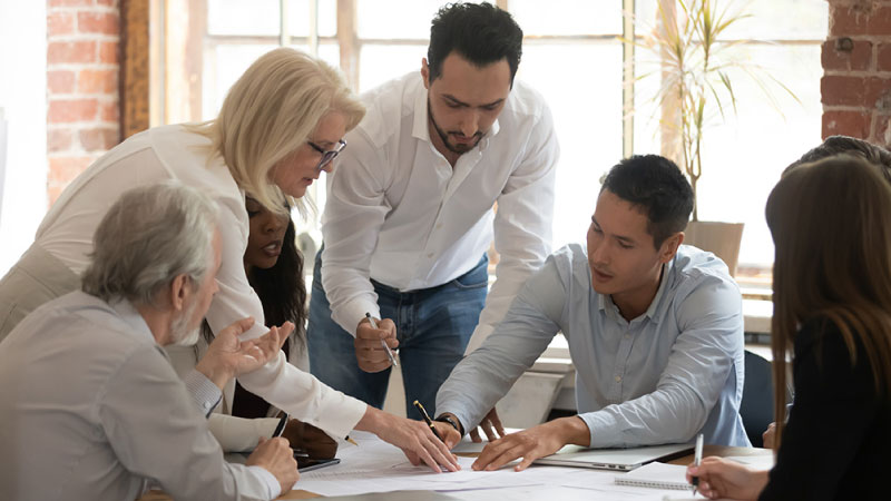 Group of workers discussing division, branches, and regions