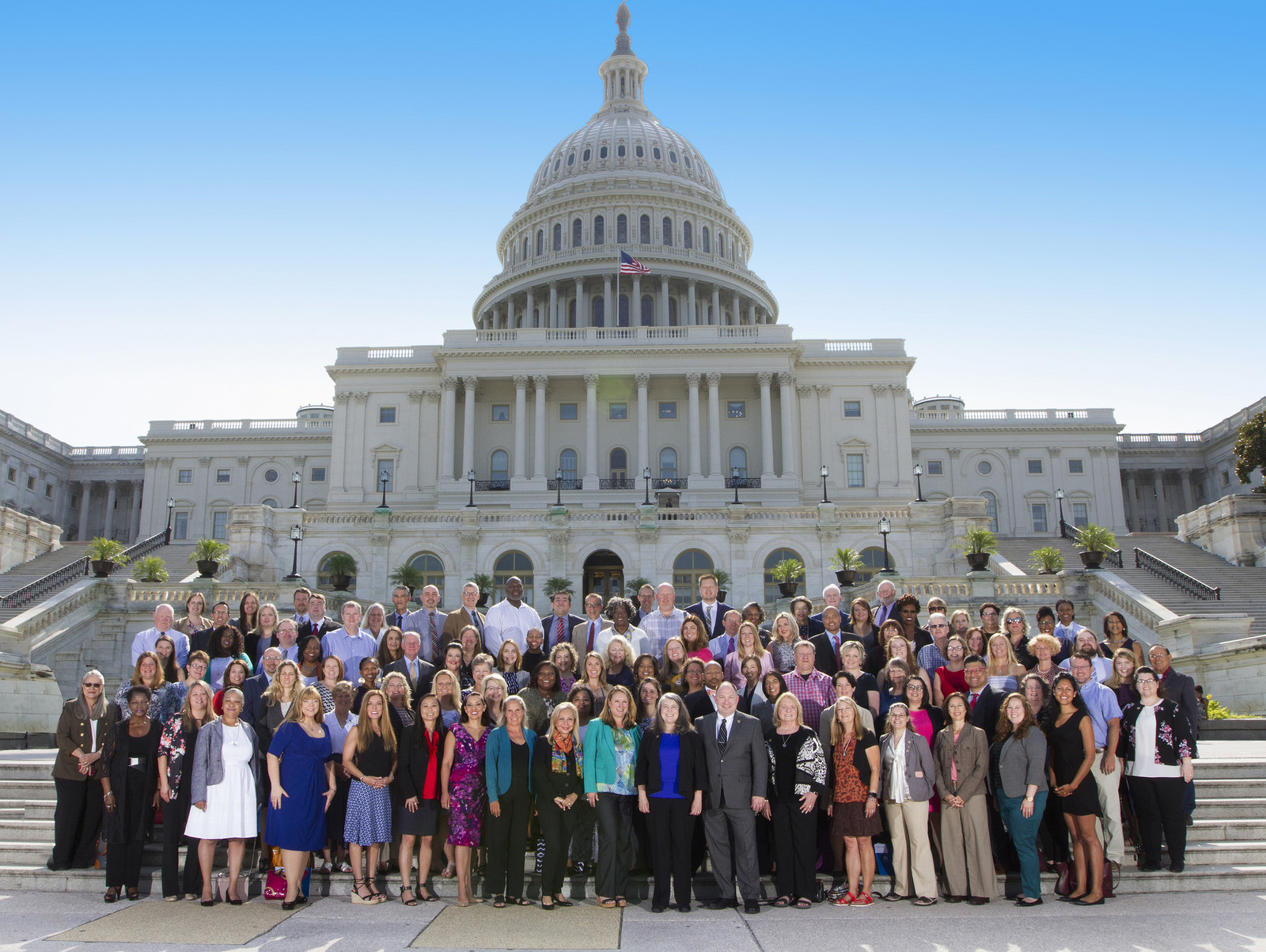 Diverse group of counselors in front of the U.S. Capitol building.
