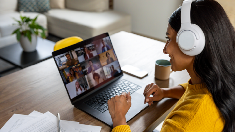 Woman watching virtual career fair on laptop