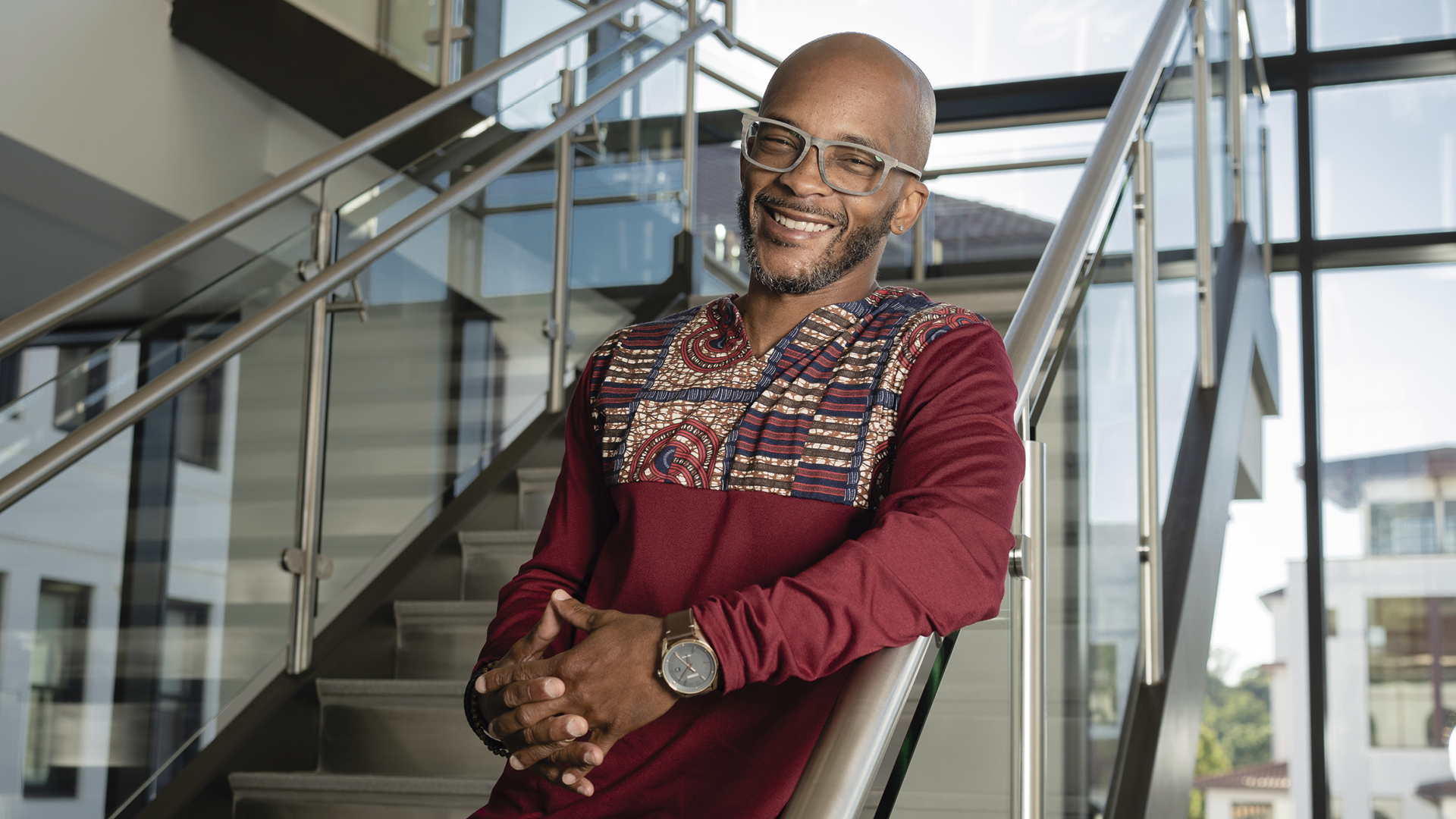 Smiling black man standing on the stairs