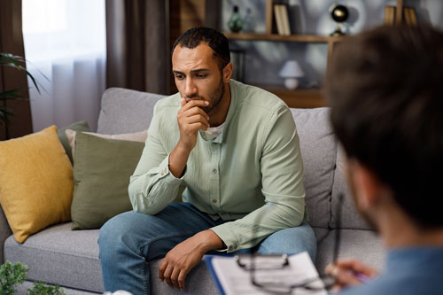 Man and therapist talking