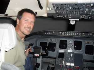 Gregory Moffatt sitting in the cockpit of a CRJ700