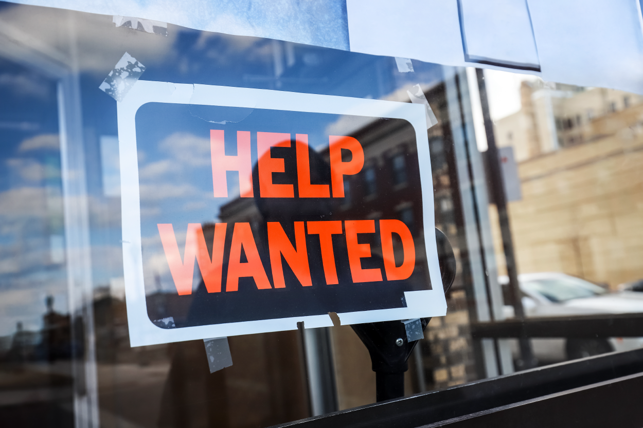 Help wanted sign taped in window