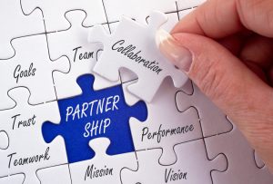 puzzle pieces with missing one indicating need for partnership and collaboration 